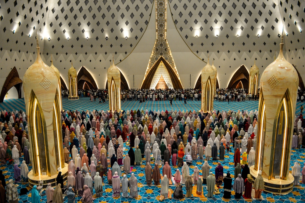 Indonesian Muslims offer the evening prayers called "Tarawih" at the Grand Mosque of Al Jabbar on the first night of holy fasting month of Ramadan