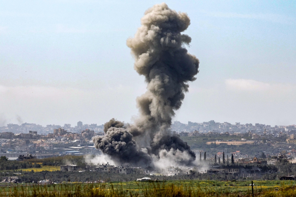 This picture shows a smoke plume rising during Israeli bombardment in the Gaza Strip. — AFP 