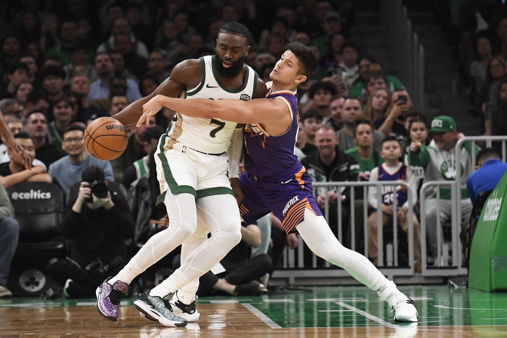 hoenix Suns guard Grayson Allen (8) tries to steal the ball from Boston Celtics guard Jaylen Brown (7) during the first half at TD Garden