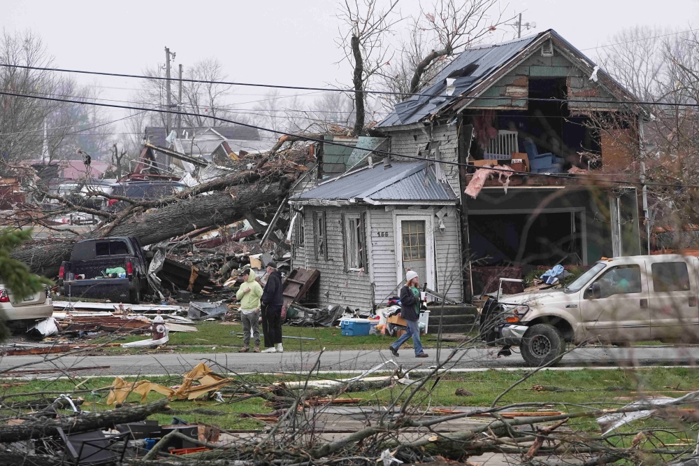 People observe the damage after an overnight tornado tore through Lakeview, Ohio, US
