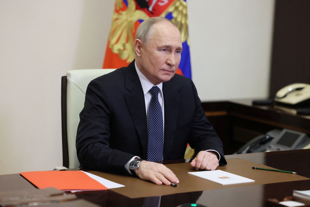 Russian President Vladimir Putin chairs a meeting with members of the Security Council via video link at the Novo-Ogaryovo state residence outside Moscow