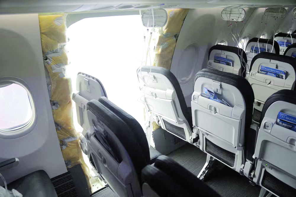 A gaping hole where the door panel had been on the Alaska Airlines Boeing 737 Max 9. — Reuters