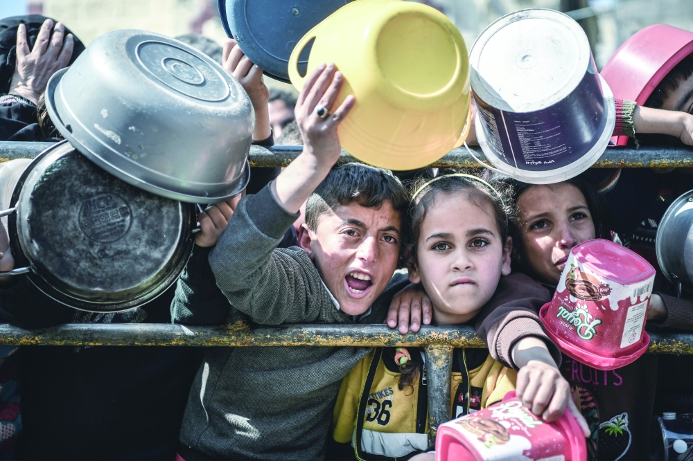 Muhammad, 11-year-old and Reham, 9-year-old, stand in front of one of the food distribution centres in Rafah, south of the Gaza Strip. 

“Every day I walk for 2 kilometers and spend over 5 hours in order to provide one meal a day for my family, it is hard and tiring, but I have to do it every day without getting tired or bored, otherwise we will not eat anything,” Mohammad said.


