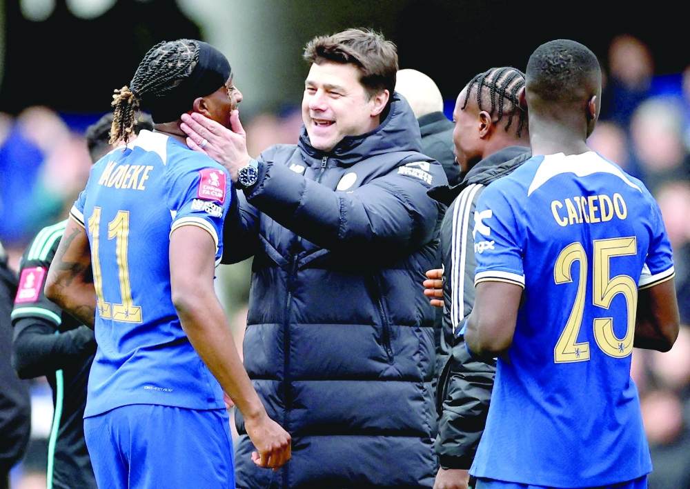 Chelsea manager Mauricio Pochettino celebrates with Noni Madueke after the match Action Images via Reuters