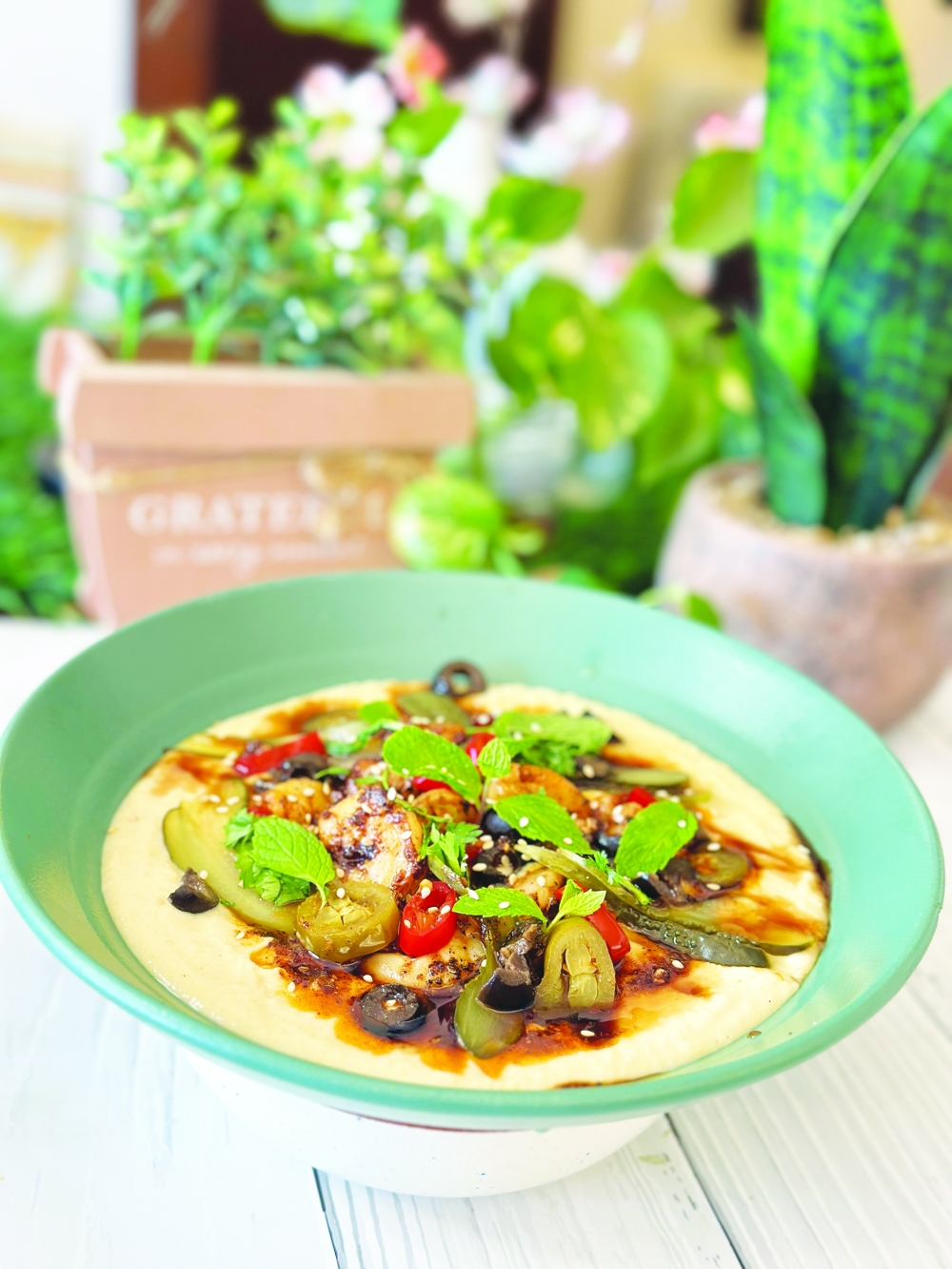 Blackened shrimps on hummus, an iftar dish