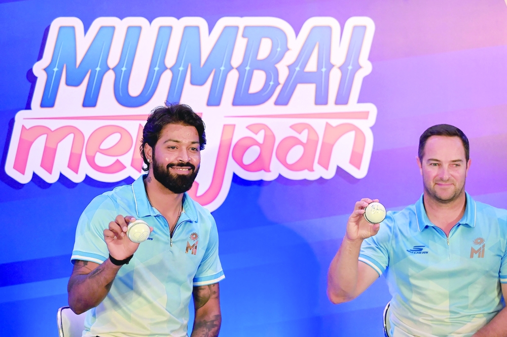 Mumbai Indians' captain Hardik Pandya (L) and coach Mark Boucher attend a press conference in Mumbai on March 18, 2024, ahead of the Indian Premier League 2024.  (Photo by Punit PARANJPE and Punit PARANJPE / AFP)

