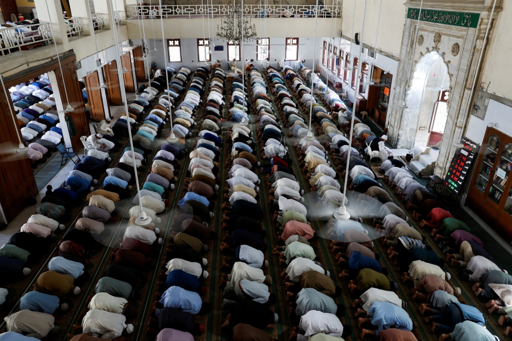 People attend Friday prayers during the fasting month of Ramadan, in Karachi