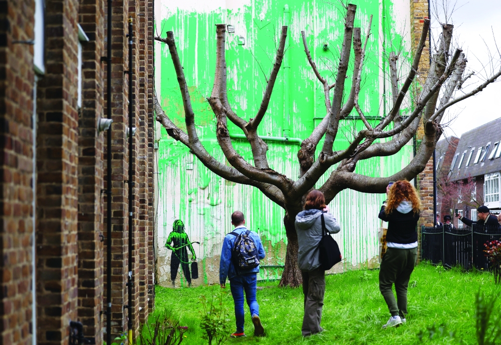 People view a new mural attributed to the British artist Banksy on a wall in north London, Britain, March 18, 2024. REUTERS/Toby Melville
