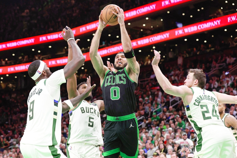 Mar 20, 2024; Boston, Massachusetts, USA; Boston Celtics forward Jayson Tatum (0) goes to the basket between Milwaukee Bucks guard Pat Connaughton (24) and forward Bobby Portis (9) during the second half at TD Garden. Mandatory Credit: Winslow Townson-USA TODAY Sports
