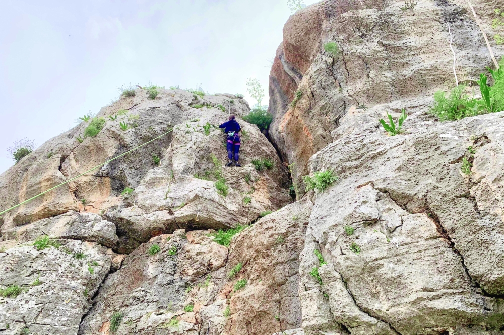 A Palestinian climber scales a rock wall at a site in Wadi al Ghul about 20 kilometres by road south of Bethlehem in the occupied West Bank. — AFP