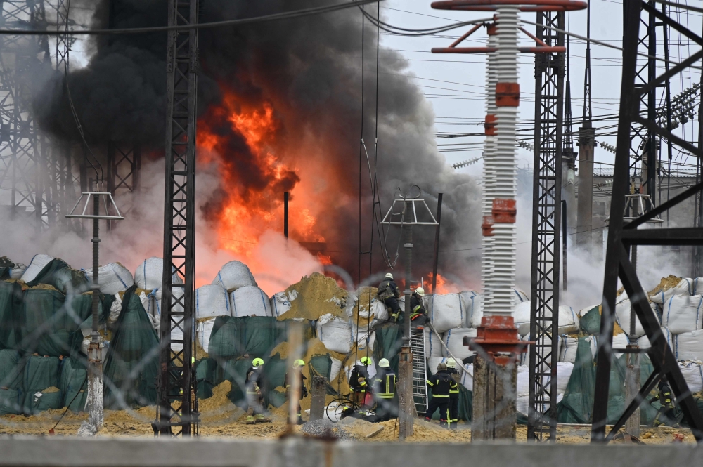 Firefighters extinguish a fire at an electrical substation after a missile attack in Kharkiv amid the Russian invasion in Ukraine