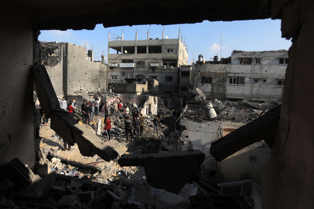 File: Local men survey the damage after an Israeli airstrike on Khan Younis, in southern Gaza.  (Yousef Masoud/The New York Times)