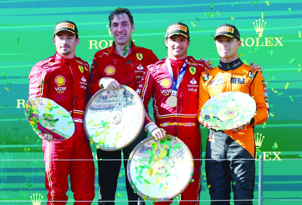 Carlos Sainz Jr celebrates with the trophy, along with second placed Ferrari's Charles Leclerc and third placed McLaren's Lando Norris.— REUTERS