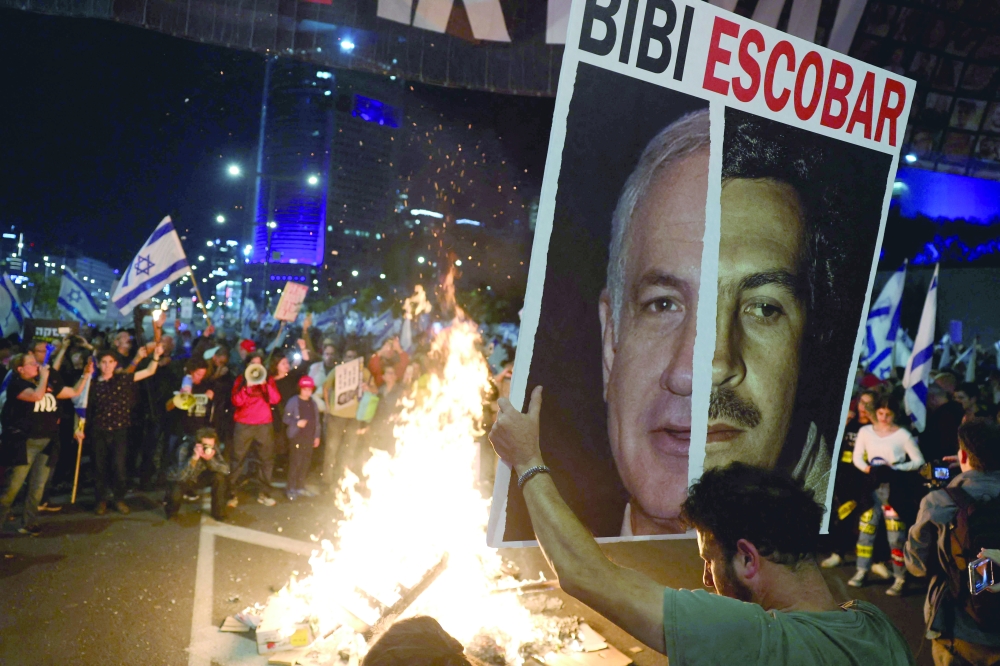 Relatives and supporters of Israeli captives attend a demonstration in front of the Defense Ministry in Tel Aviv. — AFP 
