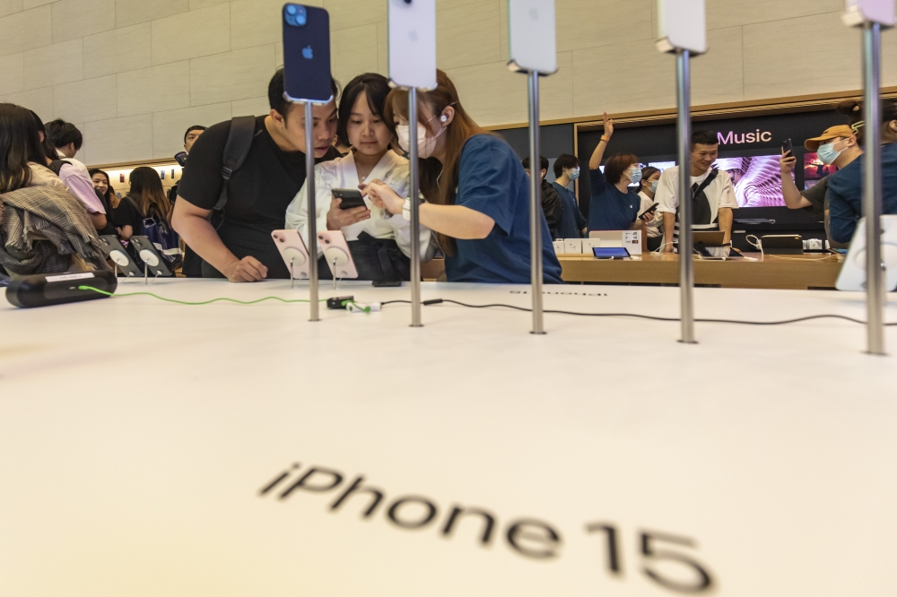 Customers check out the newly launched iPhone 15 at an Apple Store in Shanghai, 