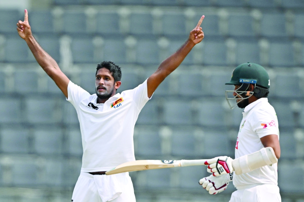 Sri Lanka's Kasun Rajitha (L) celebrates after taking the wicket of Bangladesh's Khaled Ahmed during the fourth day of the first Test cricket match between Bangladesh and Sri Lanka at the Sylhet International Cricket Stadium in Sylhet on March 25, 2024.