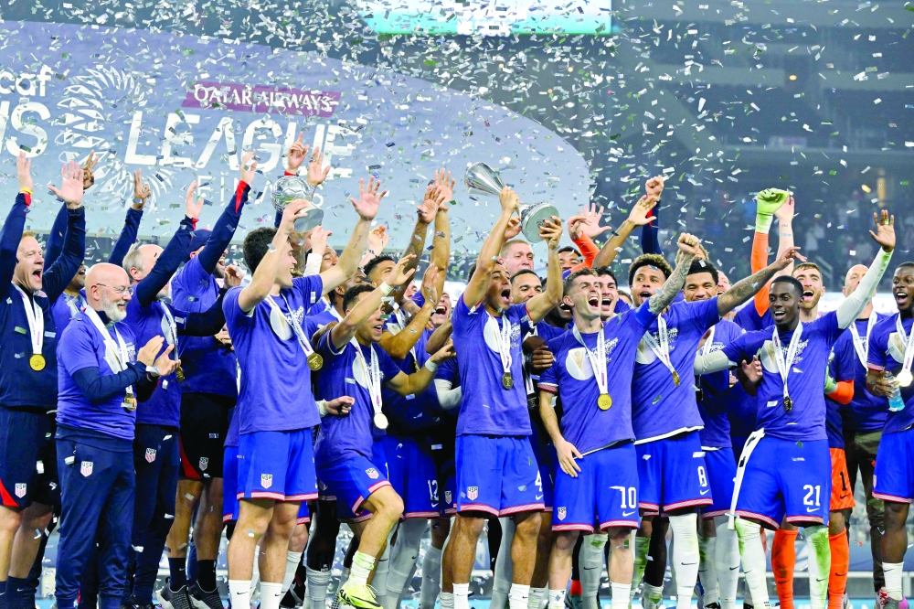Tyler Adams (4) raises the trophy and celebrates with his teammates.— USA TODAY Sports