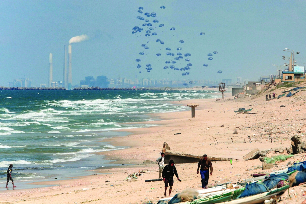 Humanitarian aid is dropped on the Gaza Strip, west of Gaza City. — AFP 