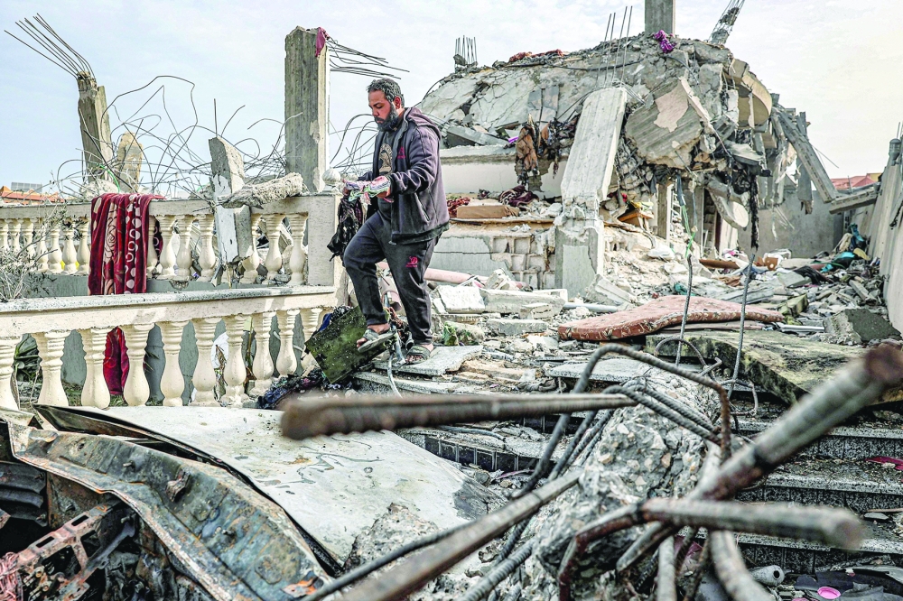 A man inspects the rubble of a building destroyed by Israeli bombardment, in Rafah. — AFP  