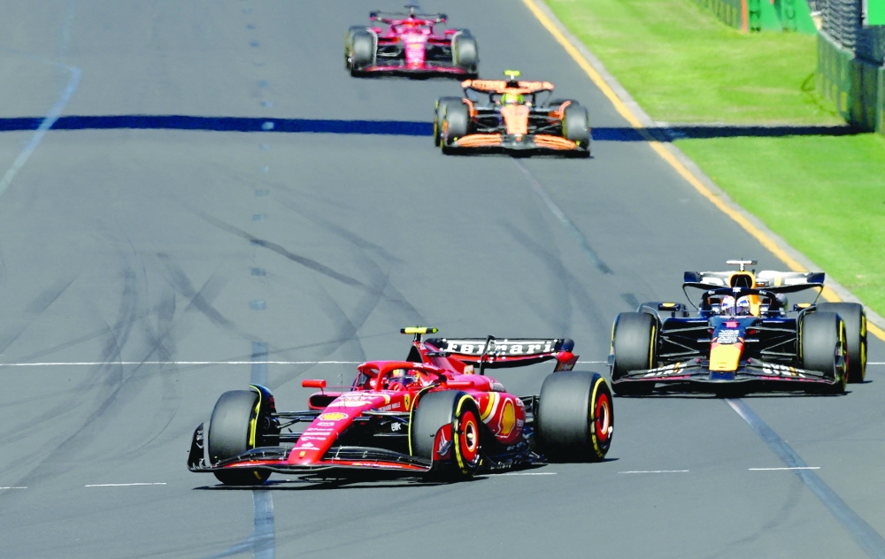 Formula One F1 - Australian Grand Prix - Melbourne Grand Prix Circuit, Melbourne, Australia - March 24, 2024 Ferrari's Carlos Sainz Jr. and Red Bull's Max Verstappen in action during the race REUTERS/Jaimi Joy
