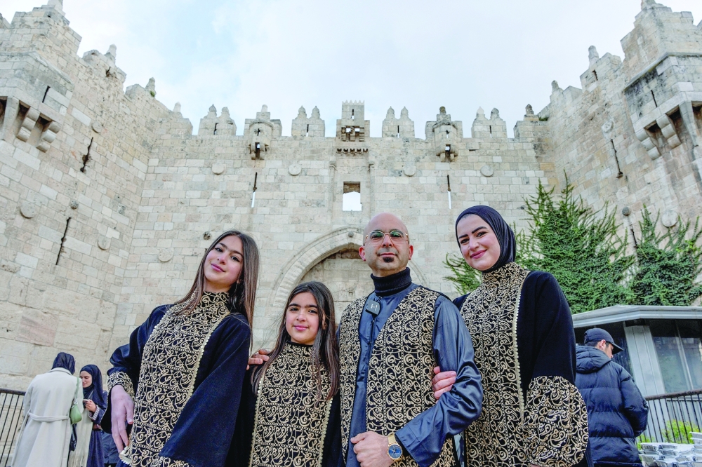 A Palestinian family poses for a photo as they mark an Iftar at the Al Aqsa mosque in Jerusalem on Tuesday. — Reuters