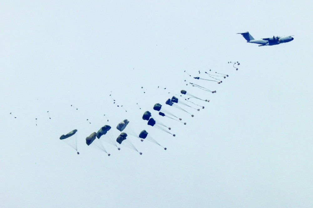 This picture shows a military aircraft releasing parachutes of humanitarian aid over Gaza. — AFP 