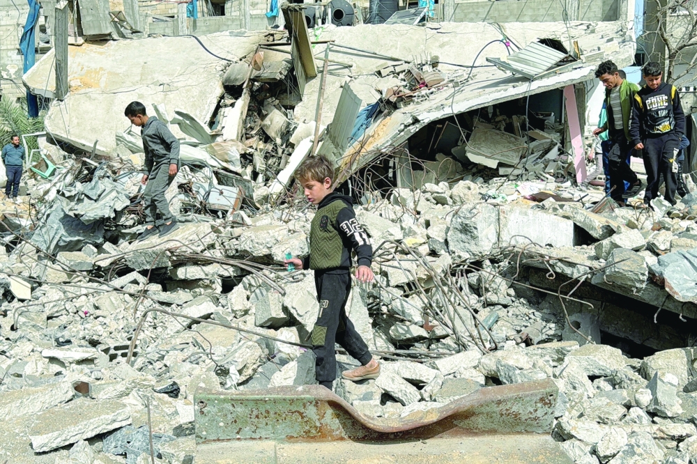 A Palestinian boy walks on the site of an Israeli strike, in Rafah. — Reuters 