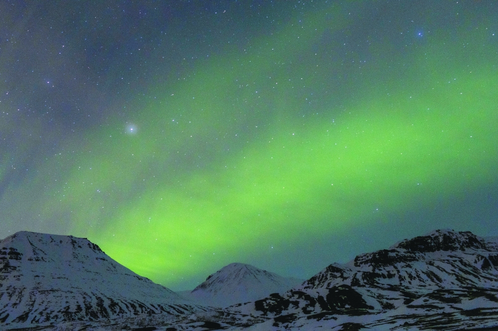 The northern lights rise in the night sky in Iceland on March 9, 2024. (Sigga Ella/The New York Times)