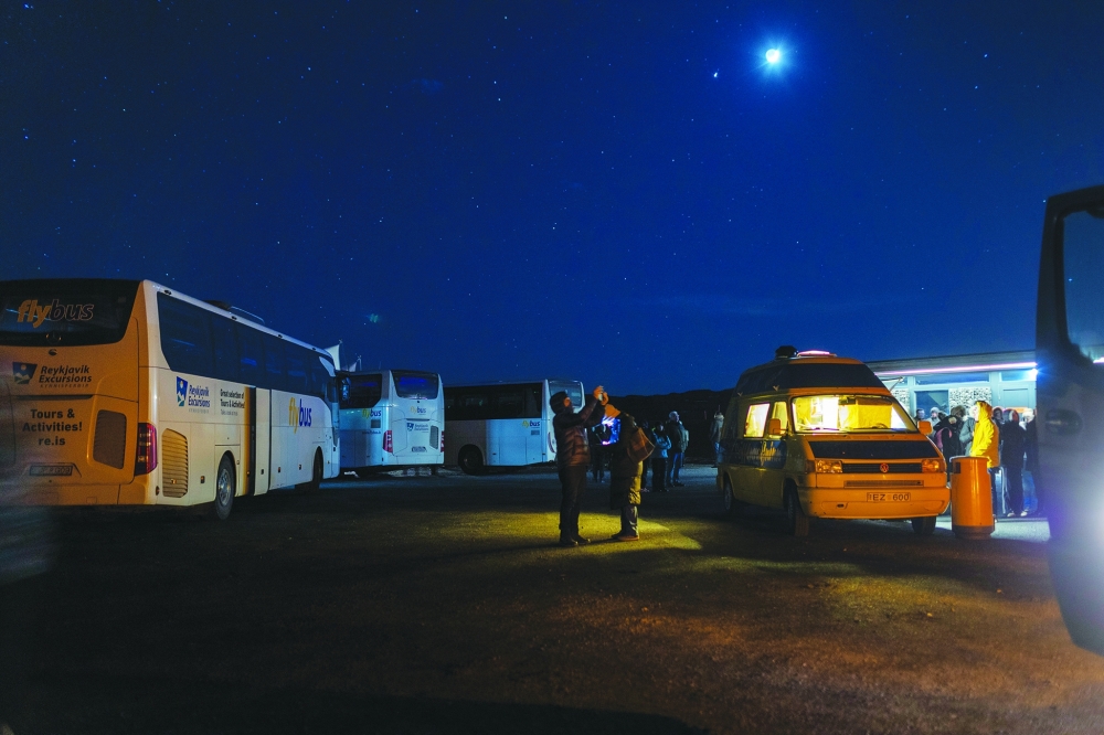 Tourists hoping to see the northern lights board night excursion buses in Reykjavik, Iceland on March 13, 2024. (Sigga Ella/The New York Times)
