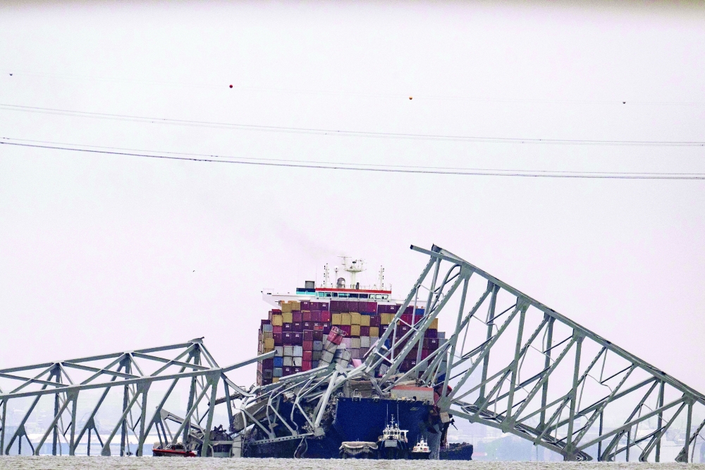 The collapsed Francis Scott Key Bridge lies on top of the container ship Dali in Baltimore, Maryland. - AFP