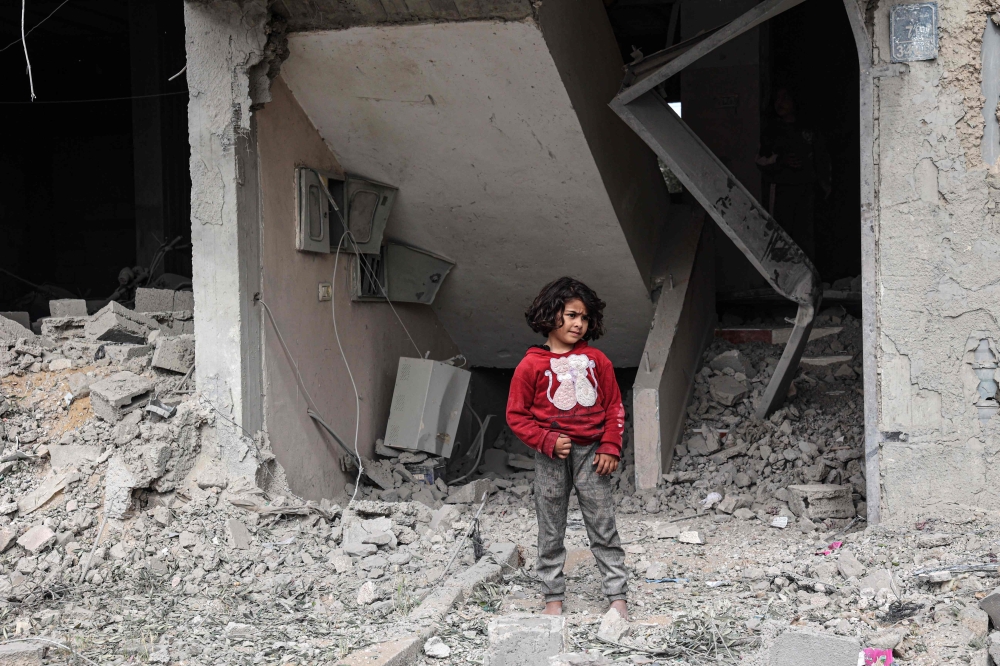 A Palestinian inspects the damage to a building 