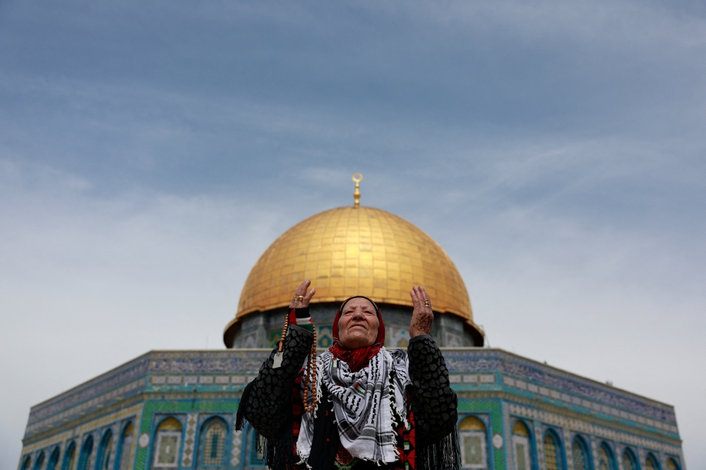 A worshipper attends the Friday prayers during the holy month of Ramadhan on the Al-Aqsa compound in Jerusalem's Old City. — Reuters