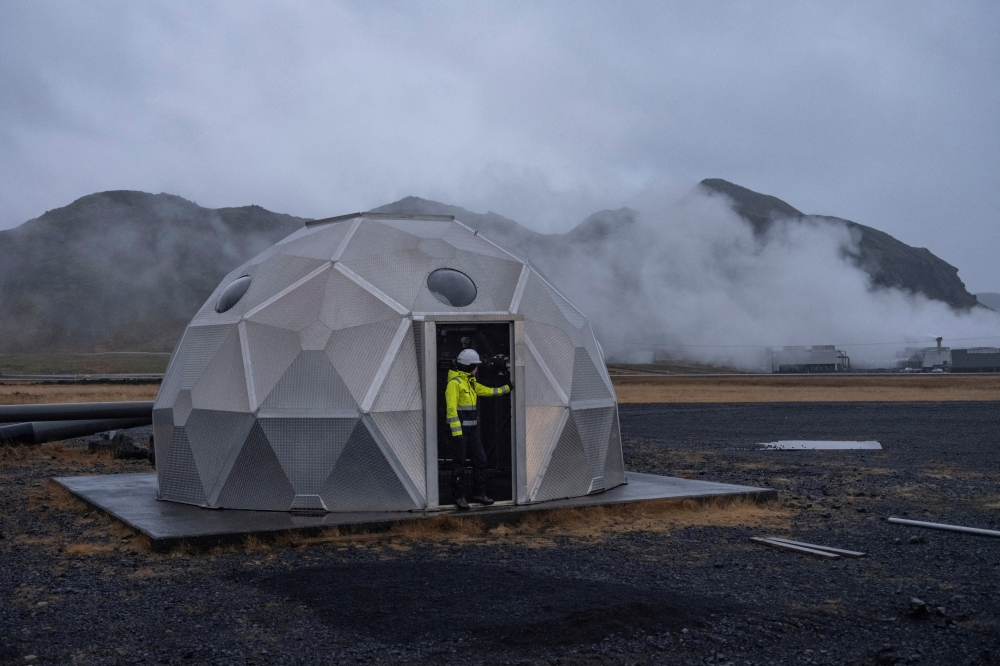 An employee of Icelandic startup Carbfix, enters the dome with injection well at its facility in Olfus, Iceland. — Reuters