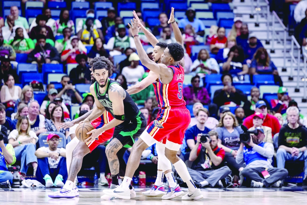 Jayson Tatum (0) is defended by Naji Marshall (8), Jones (5), and CJ McCollum (3).— USA TODAY Sports
