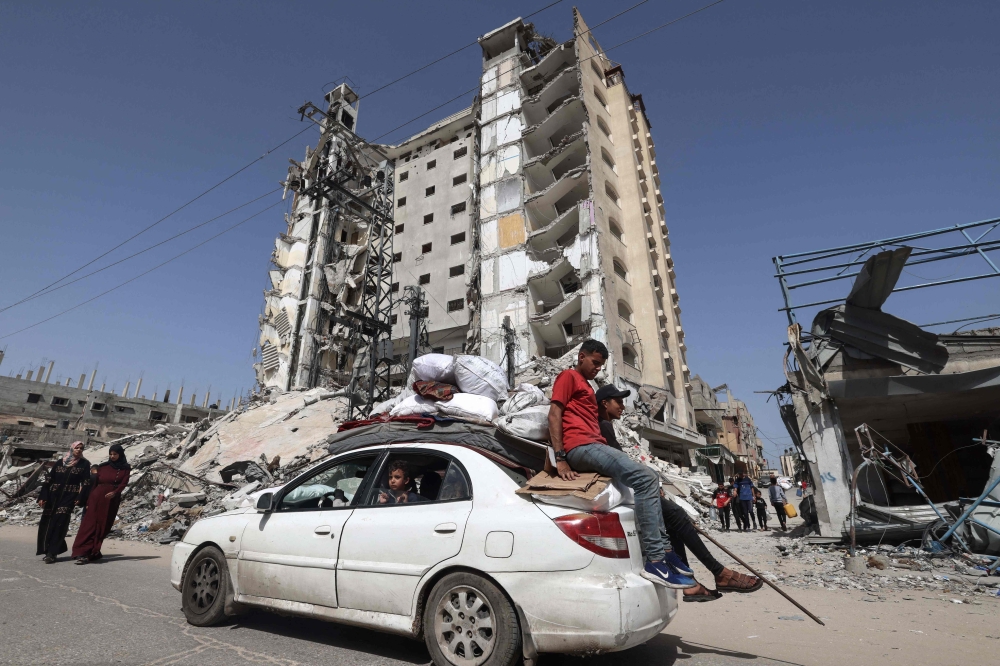 Members of a Palestinian family leave Rafah in the southern Gaza Strip with personal belongings. — AFP