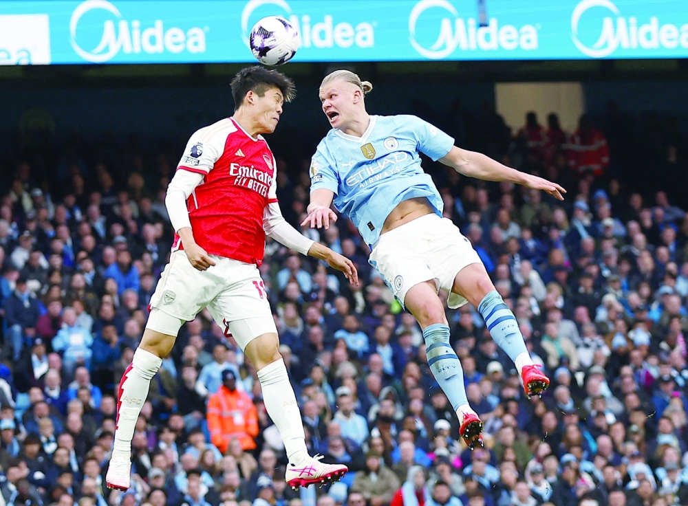 Arsenal's Takehiro Tomiyasu in action with Manchester City's Erling Braut Haaland. — Reuters