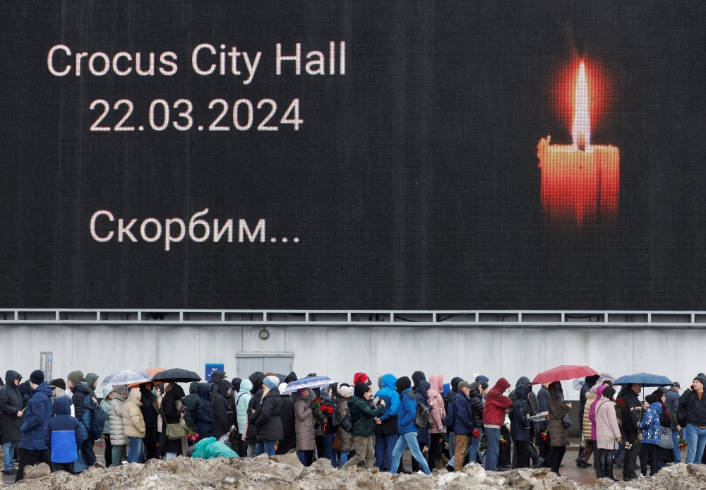 People line up to lay flowers at a makeshift memorial to the victims of a shooting attack set up outside the Crocus City Hall concert venue in the Moscow Region. — Reuters file photo 