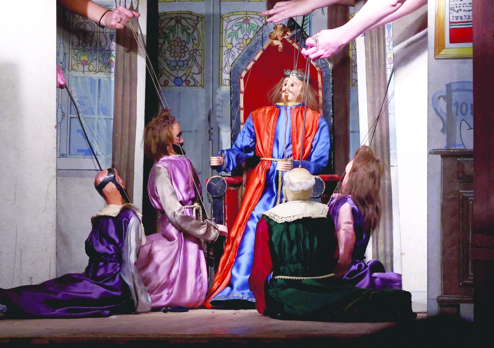 Puppetmasters operate puppets at the Royal Toone Theatre, in Brussels, Belgium, March 28, 2024. 