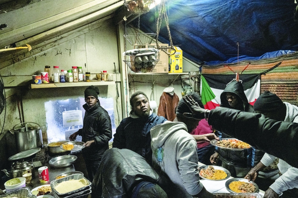 Young men prepare a Ramadan meal in the back yard of a Sundanese-run business near the Masjid At Taqwa, a mosque in the Bedford-Stuyvesant neighborhood of Brooklyn, on March 21, 2024. (Stephanie Keith/The New York Times)