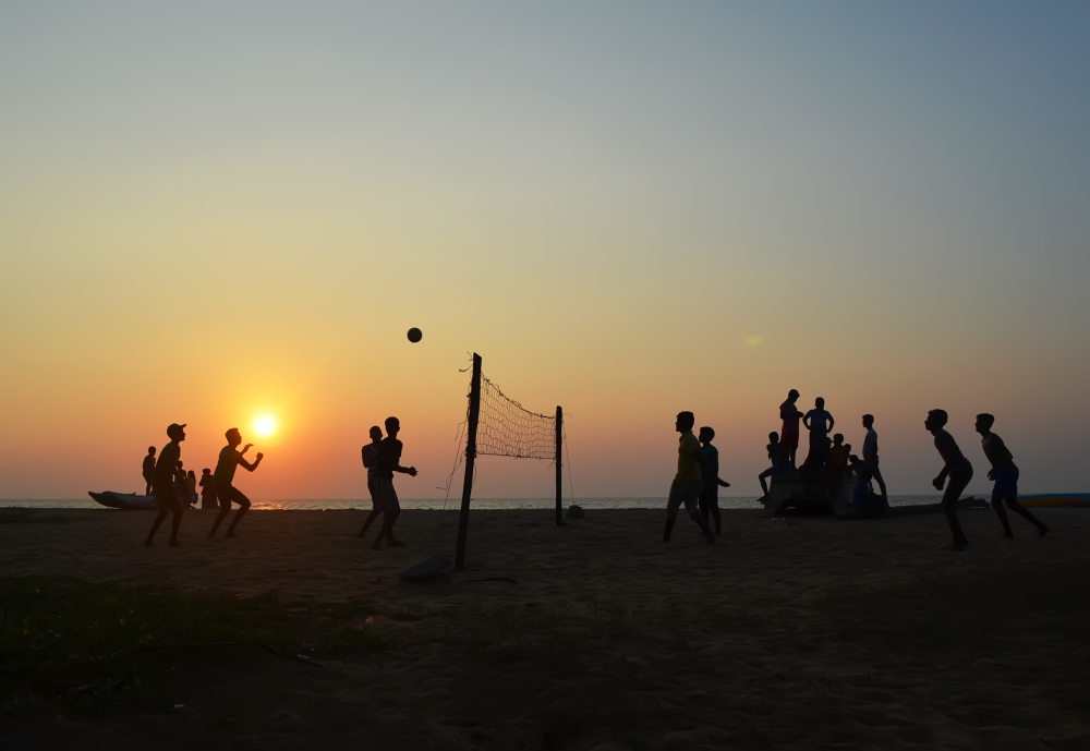 Boys,Play,Volleyball,On,The,Beach.,Sunset.,Back,Light