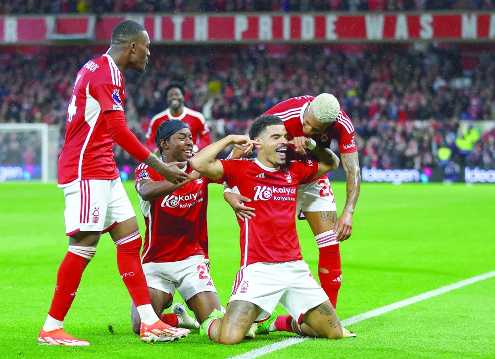 Nottingham Forest's Morgan Gibbs-White celebrates scoring their third goal with teammates.