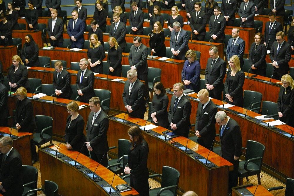 Members of Parliament observe a minute's silence as they pay their respects for the victims of the school shooting. — AFP 