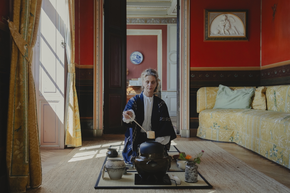 Mette Marie Kjaer, of the Sing Tehus tea company, prepares a cup of matcha tea in the room where she holds tea ceremonies at the 14th-century Gjorslev castle in Stevns, Denmark, Aug. 16, 2023. (Charlotte de la Fuente/The New York Times)