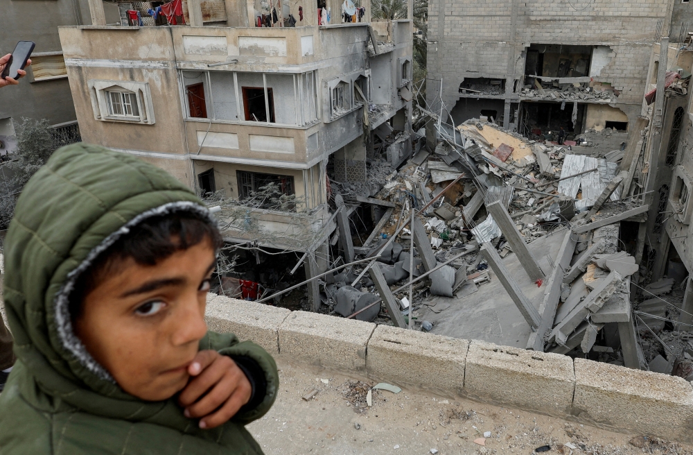 A Palestinian boy reacts near the site of an Israeli strike on a house, amid the ongoing conflict between Israel and Hamas, in Rafah, in the southern Gaza Strip. - Reuters File
