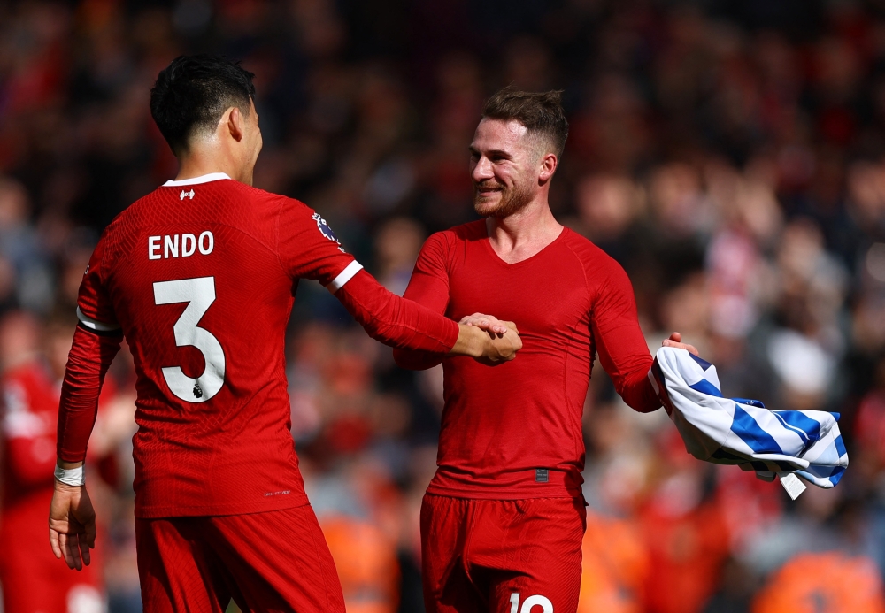Soccer Football - Premier League - Liverpool v Brighton & Hove Albion - Anfield, Liverpool, Britain - March 31, 2024 Liverpool's Wataru Endo and Alexis Mac Allister celebrate after the match REUTERS