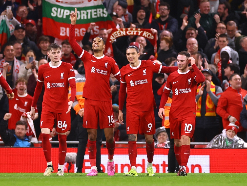 Soccer Football - Premier League - Liverpool v Sheffield United - Anfield, Liverpool, Britain - April 4, 2024 Liverpool's Cody Gakpo celebrates scoring their third goal with teammates REUTERS