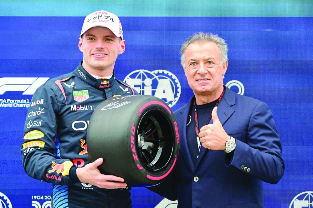 Max Verstappen (L) poses with former French F1 driver Jean Alesi.— AFP

