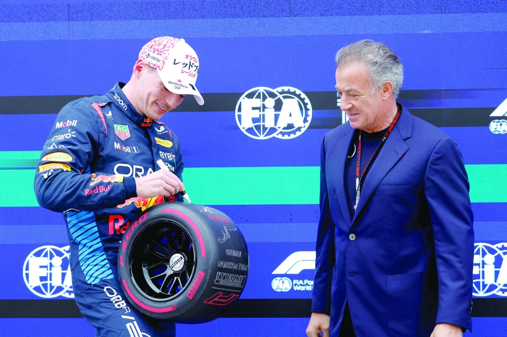 Max Verstappen receives an award from former F1 driver Jean Alesi.—REUTERS
