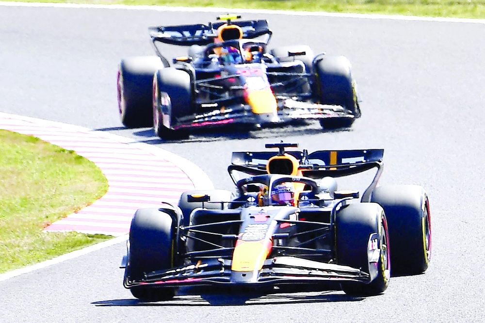Max Verstappen (front) takes a turn ahead of Red Bull.—  AFP

