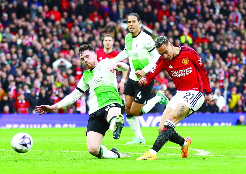 Liverpool's Andrew Robertson in action as Manchester United's Antony shoots at goal.— REUTERS
